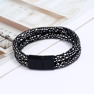 Detail of double-layer black leather bracelet with silver dots and magnetic buckle