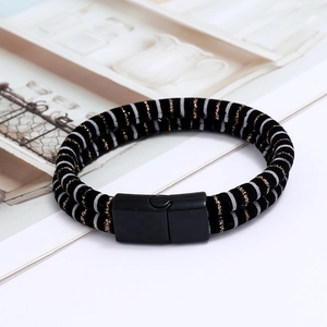 Detail of men's leather bracelet with braided cord design and black magnetic clasp