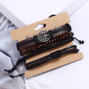 Detail of four-piece retro multilayer leather bracelets with tree of life charm