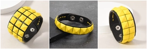 Detailansicht der gelben Pyramiden-Nietenarmbänder in ein-, zwei- und dreireihigem Design