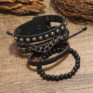 Four-piece set of vintage braided leather bracelets with fishtail and punk stud details