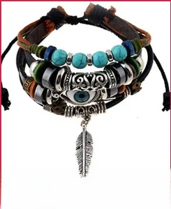 Detail view of leather bracelet with evil eye bead and silver metal feather charm