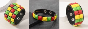 Detail eines Punk-Lederarmbands mit roten gelben und grünen Nieten und Druckknopfverschluss