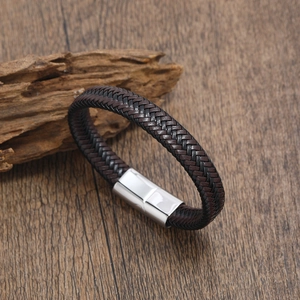 Detail of woven brown and black leather bracelet with silver magnetic steel clasp