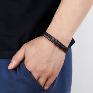Mens woven dark brown leather bracelet with magnetic steel clasp on wrist
