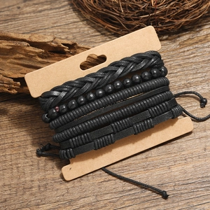 Retro multi-layer black braided leather bracelet set for men and women on wood