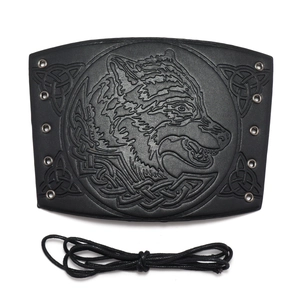 Detailed view of black PU leather wrist guard with wolf head embossing and metal eyelets