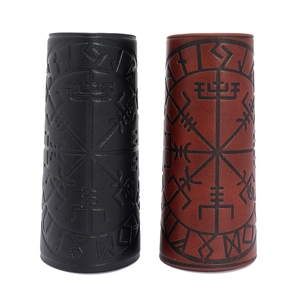 Detailed view of leather arm guards with embossed Viking Vegvisir compass symbols