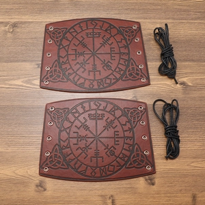 Detail of Viking arm guards featuring Vegvisir compass and runes on dark brown leather