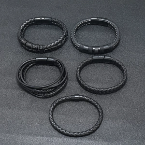 Detail of five-piece black braided leather bracelet set with magnetic metal buckles