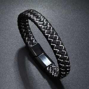 Close-up of black braided leather men's bracelet with a silver accent and magnetic metal clasp