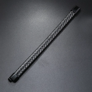 Macro detail of black braided leather bracelet with silver wire and matte magnetic clasp