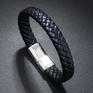 Detail of black and blue braided leather bracelet with a silver magnetic metal clasp