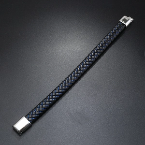 Detail of woven black leather bracelet with blue accents and silver magnetic buckle