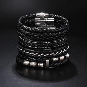 Detail view of a 4-piece set of men's black leather braided bracelets with silver metal accents