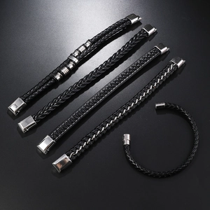 Close-up of five-piece black woven leather bracelet set with silver metal accents