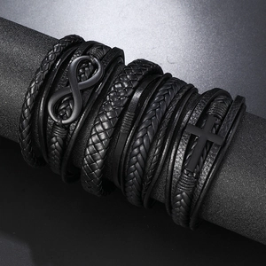 Detail of multi-layer black leather bracelet set with cross and infinity metal charms
