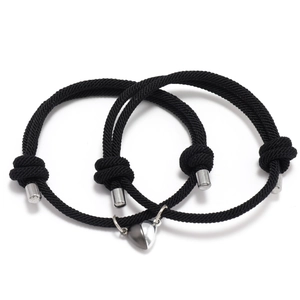 Adjustable woven magnetic couple bracelets with heart-shaped pendants in black and white