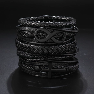 Detail of multi-layer black leather bracelet set with cross and infinity metal charms
