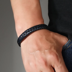 Men's minimalist black woven leather bracelet with blue stitching and magnetic clasp