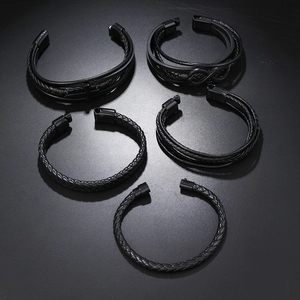 Detailed set of five black braided leather men's bracelets with magnetic metal clasps