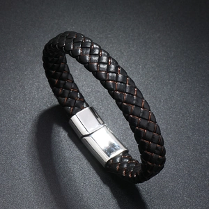 Macro shot of black braided leather bracelet with polished silver magnetic clasp