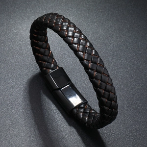 Detail of men's braided leather bracelet with a black mirrored metallic magnetic clasp