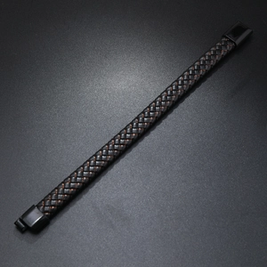 Detail of black braided leather bracelet with copper thread and matte magnetic clasp