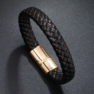 Close-up of men's black braided leather bracelet with a polished gold magnetic clasp