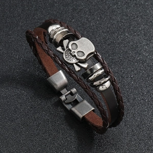 Multilayer leather punk bracelet featuring vintage metal skull and crossbones ornament
