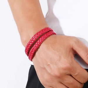 Detail view of a double-layered red woven leather bracelet with magnetic clasp on wrist