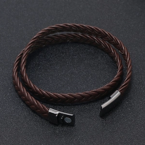 Detail of multi-layer brown braided leather cord and dark metallic magnetic clasp closure