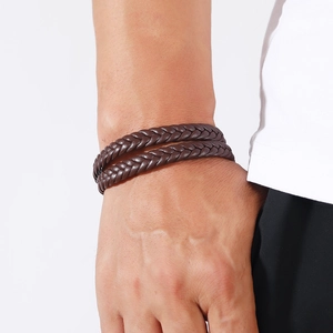 Detail of dark brown multi-strand braided leather bracelet with magnetic clasp for men