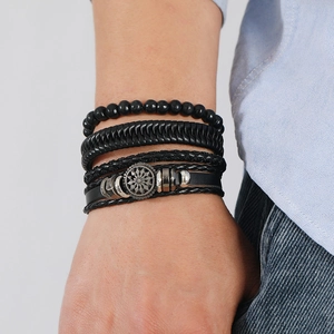 Detail shot of men's multilayer black leather braided bracelets with beads and metal charm