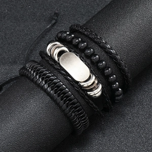 Detail view of 4-piece vintage black leather braided bracelets with beads on a display