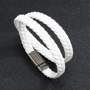 Close-up of white braided double-layer leather bracelet with black magnetic clasp