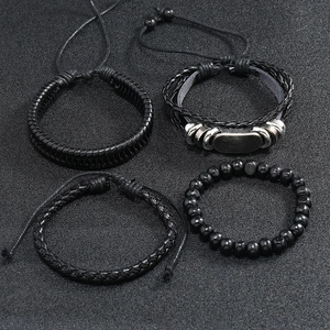 Detail view of a 4-piece set of men's vintage multi-layer braided leather bracelets in black