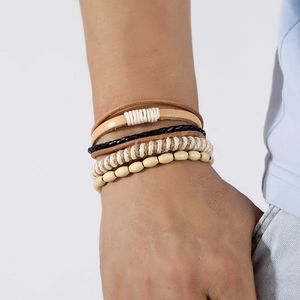 Detail of multi-layer men's bracelet set with leather, braided rope and wooden beads