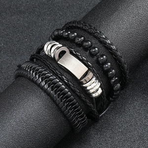 Close-up of vintage multi-layer braided leather bracelet with black beads and metal clasp
