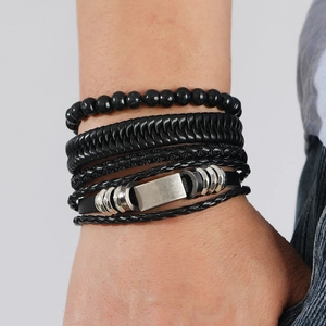 Detail view of men vintage multilayer hand-woven leather bracelets with metal charms