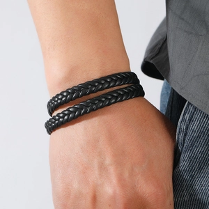 Close-up of black braided leather multi-layer wrap bracelet on a man's wrist