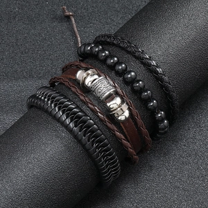 Detail view of four-piece vintage layered leather bracelets with beads for men