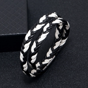 Close-up of black and white braided leather bracelet with matte magnetic buckle