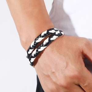 Detailed view of black and white multi-strand woven leather bracelet with magnetic clasp