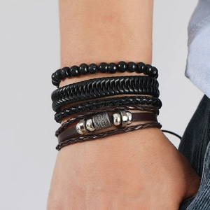Macro detail of layered vintage leather bracelet with wooden beads and silver metal tubes