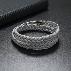 Detailed macro view of gray braided leather cord and polished silver magnetic clasp