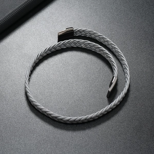 Detail of grey multi-layer braided leather bracelet with high-quality gunmetal magnetic clasp
