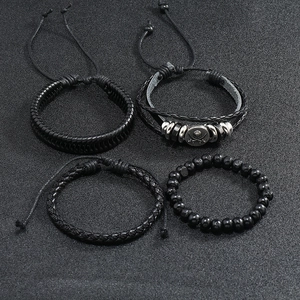 Detailed view of four-piece men's vintage black woven leather and beaded bracelet set