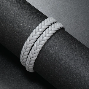 Close-up of grey braided multi-layer leather bracelet on black display stand