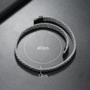 Macro shot showing 40.0cm length and 1.0cm width of grey braided leather bracelet